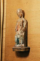 A 14th/15th-century Italian polychromed pine Madonna and Child, seated with carved drapery, hollowed