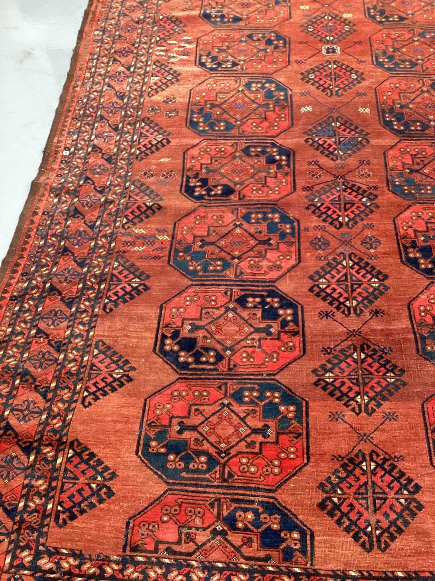 A large antique "Old country house" red ground Afghan carpet, with three rows of elephant foot - Image 15 of 28