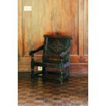 A 17th-century oak wainscot chair, with lozenge carved panel back, of low and wide proportions, 75