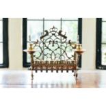 An 18th century Dutch/German brass menorah, with row of eight sconces and side lights, fretwork