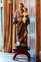 A polychrome painted and parcel gilt ceramic standing figure of St Joseph and the infant Christ, 126