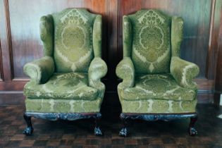 A pair of George III style upholstered wing armchairs, 20th century, green damask upholstered, on