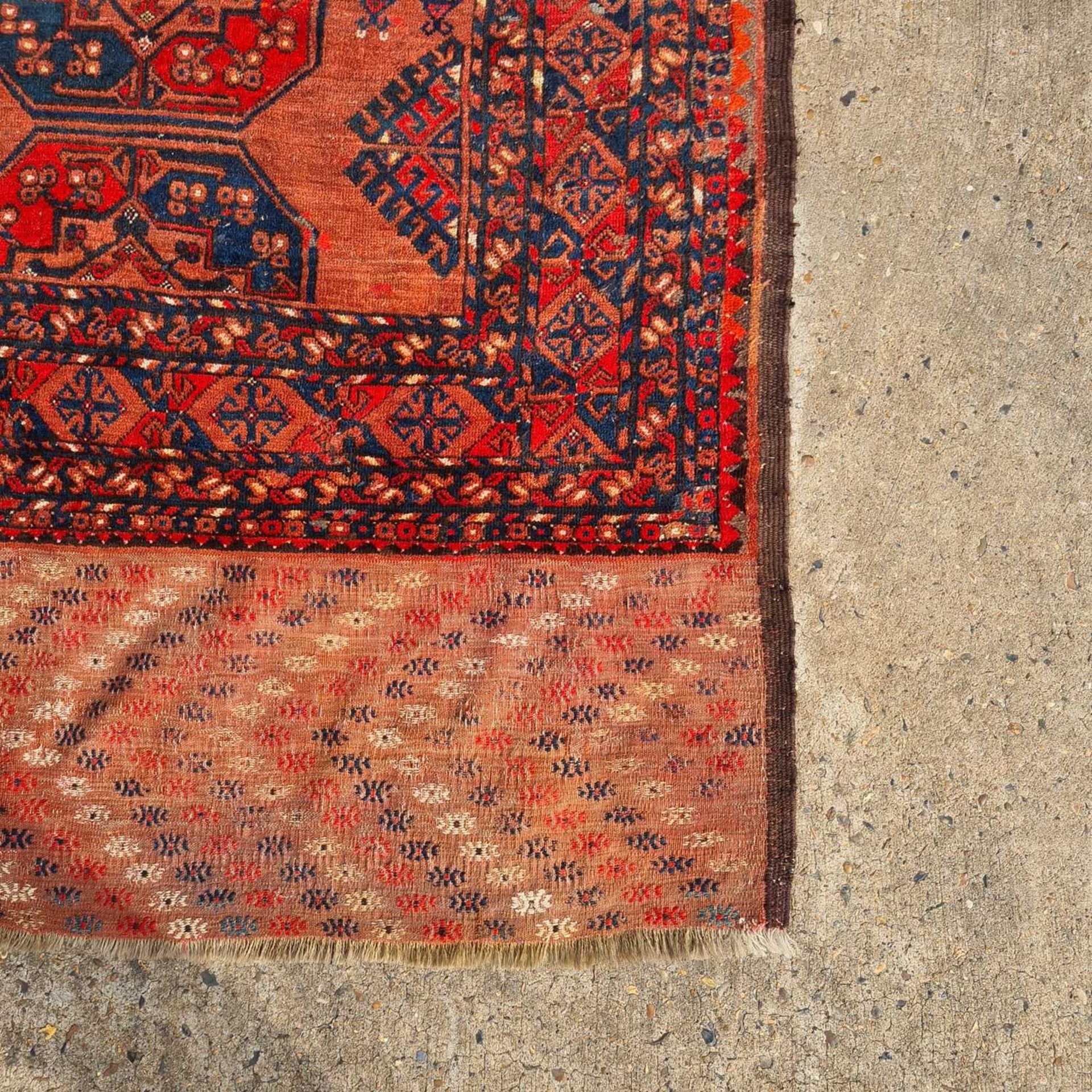 A large antique "Old country house" red ground Afghan carpet, with three rows of elephant foot - Image 3 of 28
