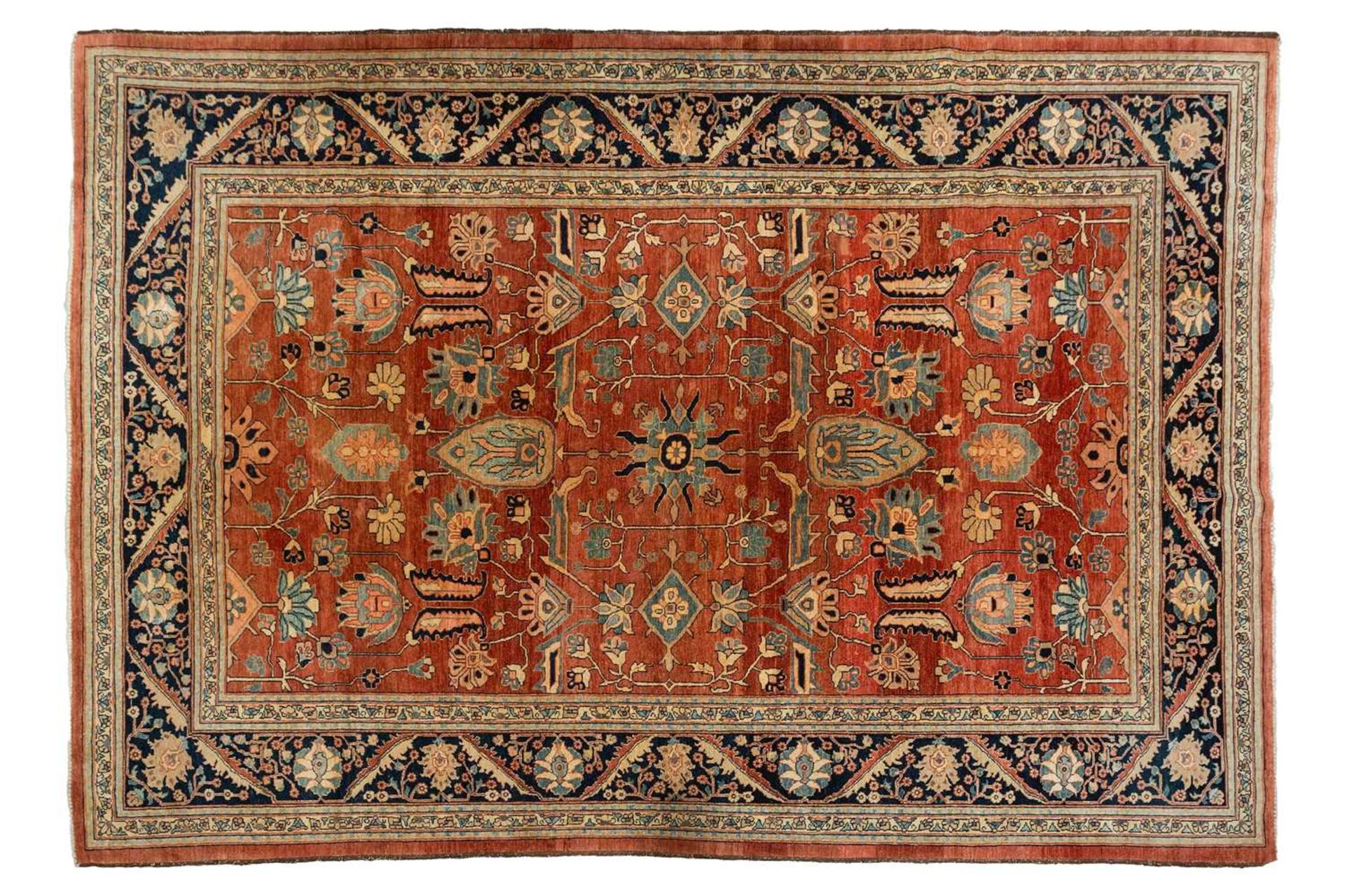 A large brick red ground Serapi-style carpet , 20th century, with central boss and geometric flowers