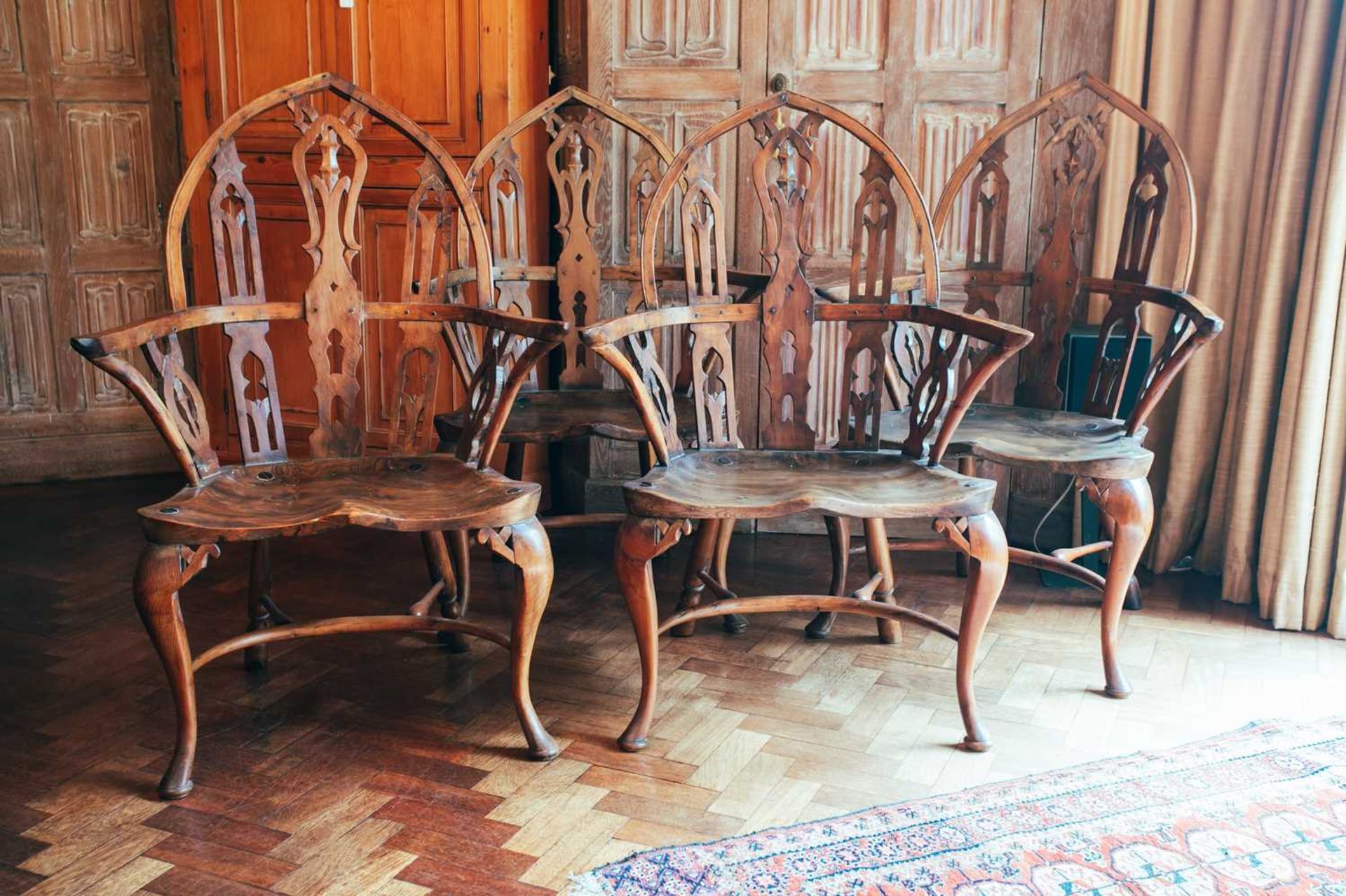 Four 18th-century style Gothic Windsor yew armchairs, probably 19th century, on cabriole front