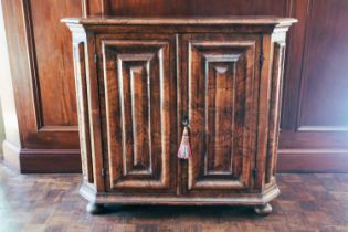A German Baroque walnut cabinet, 18th century and later the rectangular top with chamfered