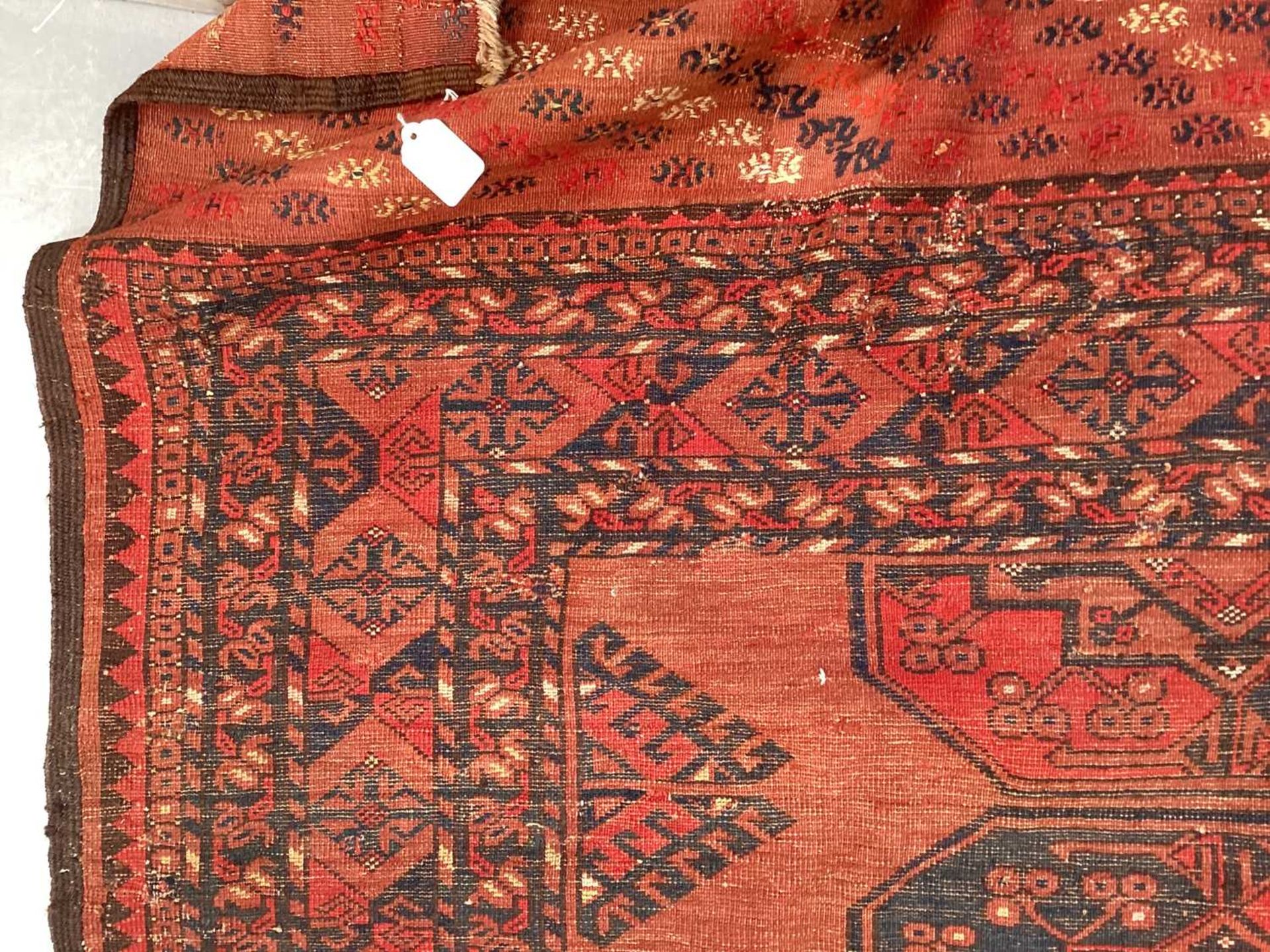 A large antique "Old country house" red ground Afghan carpet, with three rows of elephant foot - Image 27 of 28