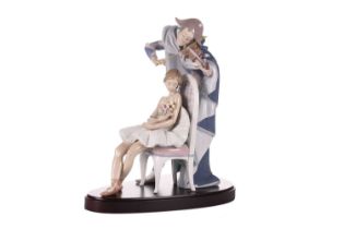 A large Lladro figure, 'Jester's Serenade', modelled as a ballerina with bouquet of flowers seated