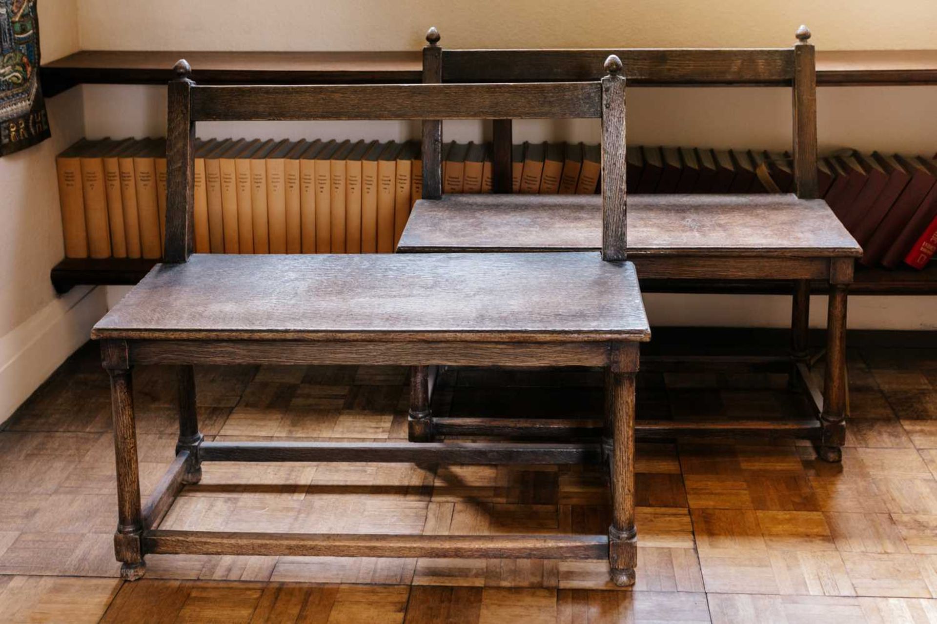 A close pair of rustic oak window seats, French, 19th century with open backs over solid seats and