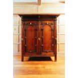 An 18th-century Dutch oak Schrank, the moulded cornice above a pair of arched panel doors,