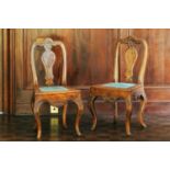 A pair of 18th century oak carved chairs, arched back, vase splat and upholstered panel seat on