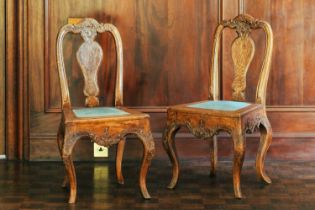 A pair of 18th century oak carved chairs, arched back, vase splat and upholstered panel seat on