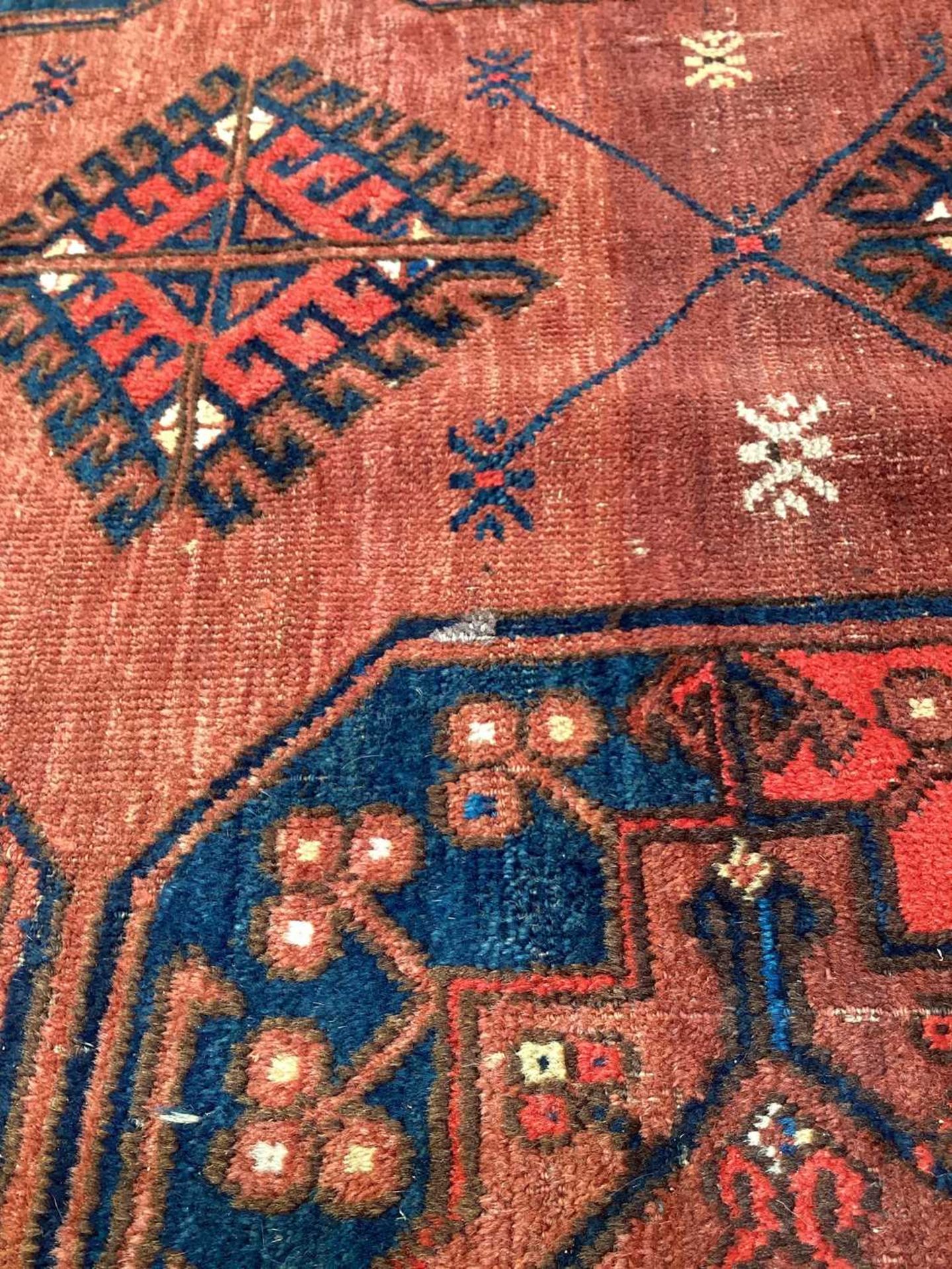 A large antique "Old country house" red ground Afghan carpet, with three rows of elephant foot - Image 11 of 28