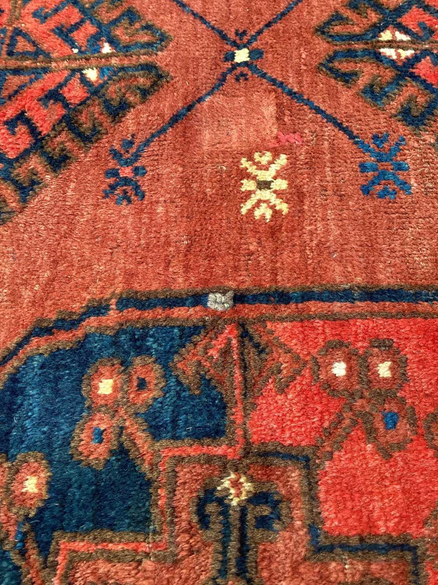 A large antique "Old country house" red ground Afghan carpet, with three rows of elephant foot - Image 10 of 28