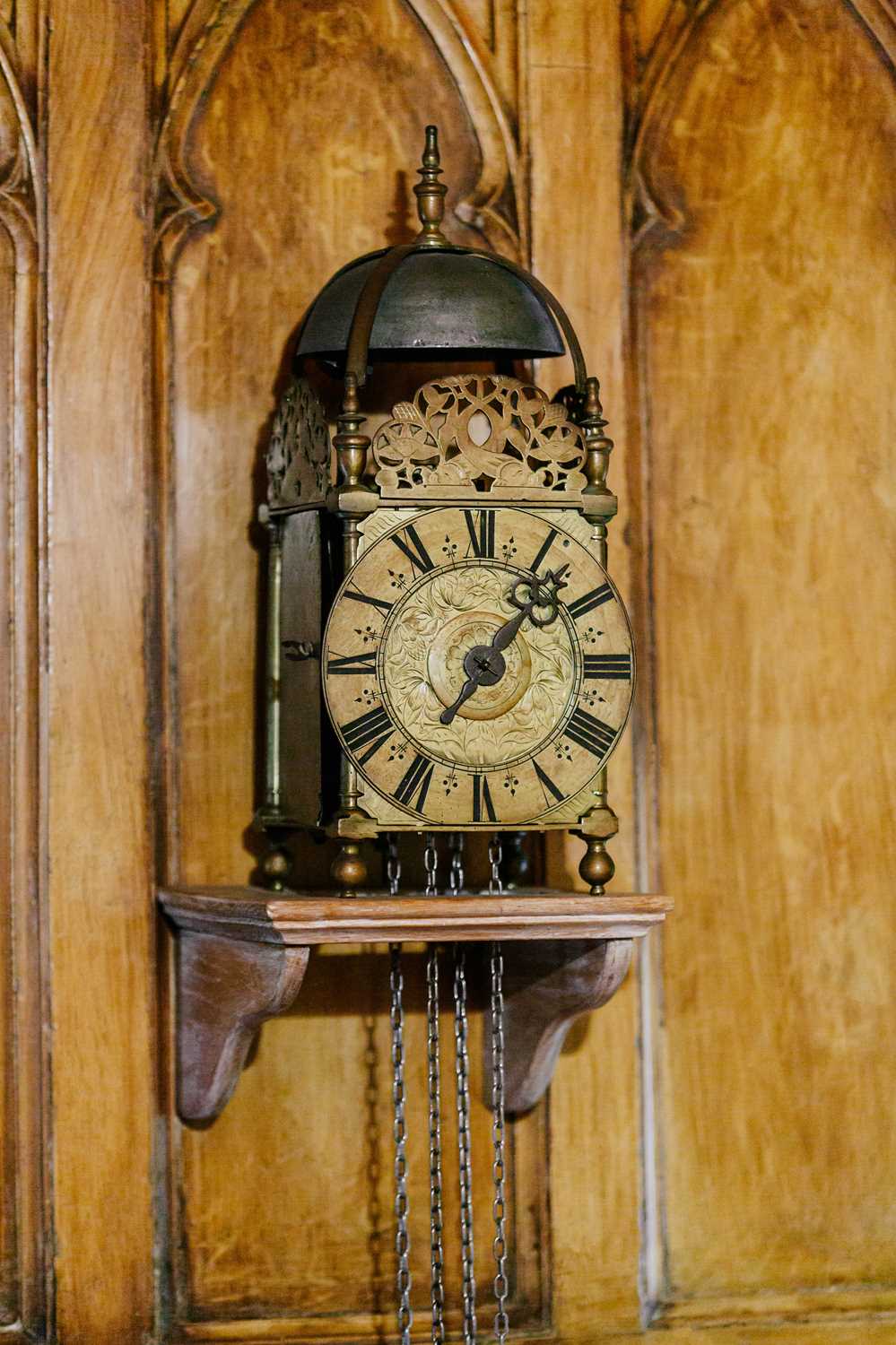 A late 17th century brass lantern clock, unsigned, the strapped bell over acorn finials, dolphin