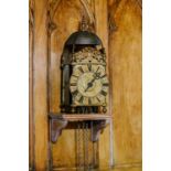 A late 17th century brass lantern clock, unsigned, the strapped bell over acorn finials, dolphin