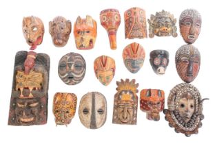 A collection of sixteen polychrome carved wood face masks, from Guatemala, India, Africa and the Far