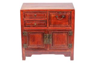A Chinese hardwood chest, with two short drawers beside a deep drawer over a pair of cupboard doors,