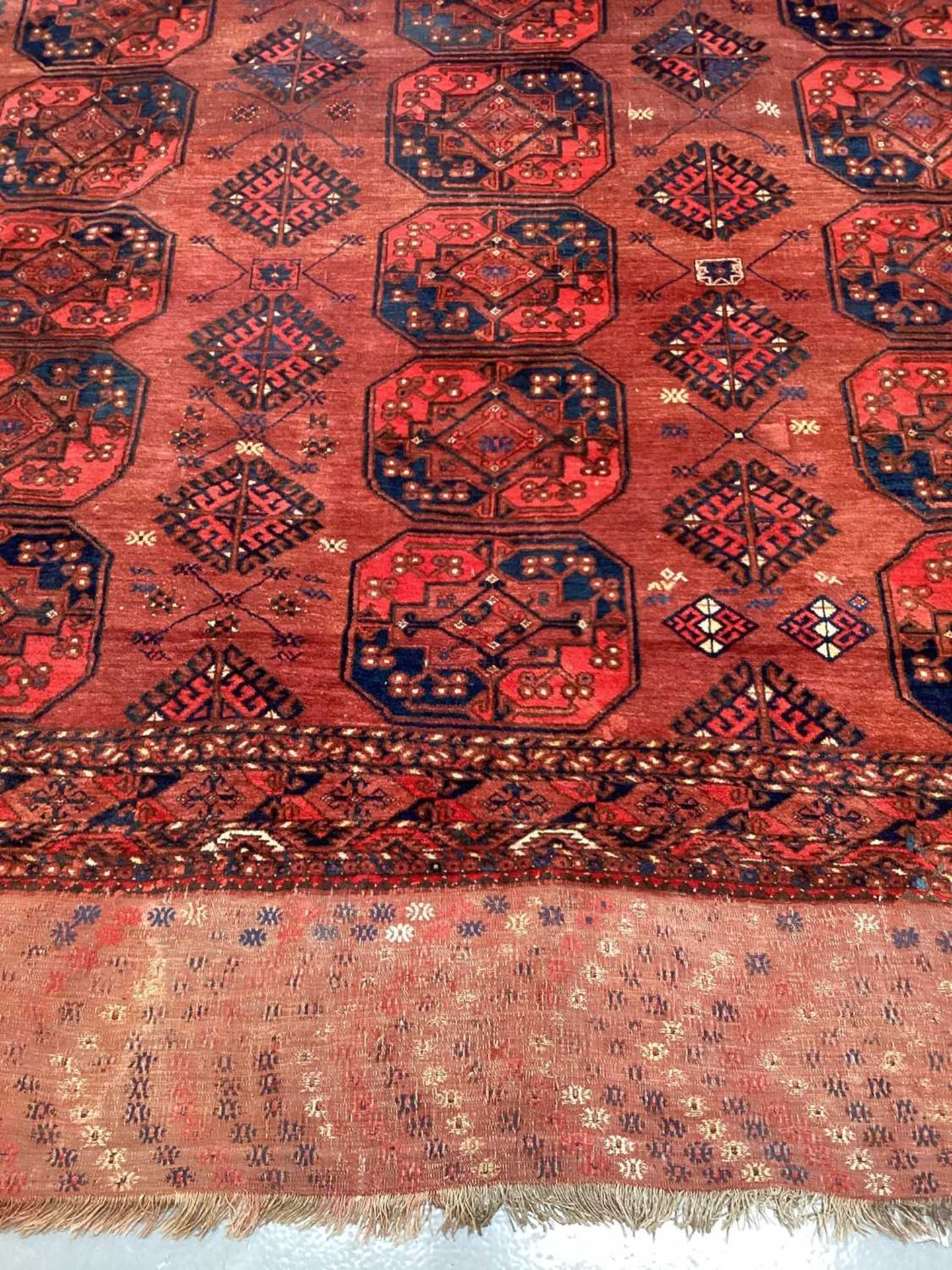 A large antique "Old country house" red ground Afghan carpet, with three rows of elephant foot - Image 7 of 28