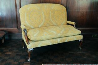 A George III small settee, with upholstered rectangular back, Tudor rose carved mahogany arm