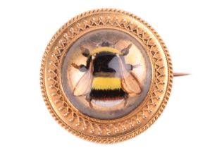 An Essex crystal bee brooch, containing a round rock crystal cabochon with reverse intaglio