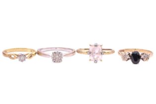 A collection of four gem set rings, including a sapphire and diamond three-stone ring, the