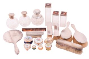 A silver 1950s dressing table set with additional perfume bottles and pill boxes comprising a hand