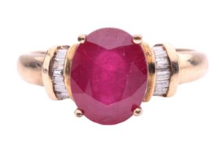 A glass-filled ruby and diamond ring, the oval glass-filled ruby measuring 10 x 8 x 4.3mm, flanked