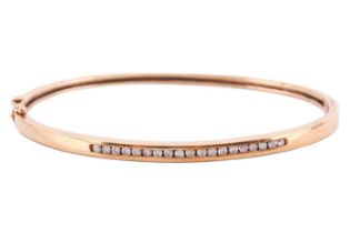 A diamond-set hinged bracelet in 9ct yellow gold, the front half of the bracelet channel-set with
