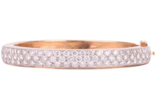 A diamond-set hinged bracelet, consisting of seventy brilliant-cut diamonds, with an estimated total