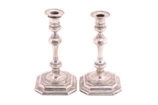 A pair of Mappin and Webb silver candlesticks, with detachable sconces on square weighted bases with