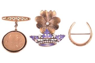A group of four brooches; to include an enamel coronet brooch in floral design, set with seed