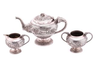 An Indian silver-plated three-piece tea service comprising a teapot a hinged cover with an