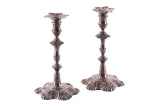 A matched pair of George III silver candlesticks one with makers mark for Ebenezer Coker 1763, the