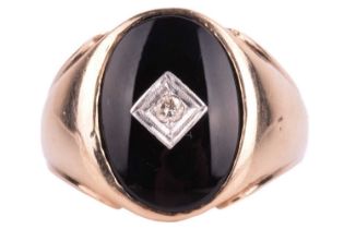 A signet ring set with onyx and diamond, the oval ring head centred with a square motif framing a