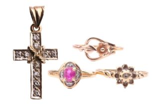 A collection of three rings and a cross pendant, comprising a ruby and diamond ring, the oval