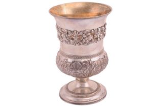 A George III silver chalice with a gilt interior featuring a flared body with a cast band of