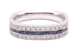 A sapphire and diamond half eternity ring, set with a row of baguette cut sapphires between round