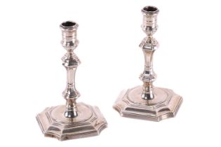 A pair of silver George I style tapersticks by James Parkes, London 1900, 11cm high, the flared base