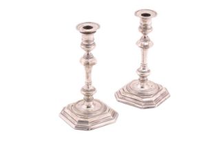A pair of silver candlesticks with detachable octagonal sconces and weighted octagonal bases, 18cm