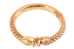 An Indian zoomorphic hinged bracelet of openwork design, the screw clasp designed as a pair of