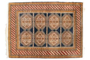 A hand-knotted rug in the Shiraz style with the inky blue ground with four panels of guls, within