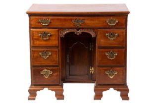 A George III mahogany kneehole desk, the crossbanded top over a long drawer and kneehole with