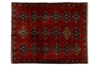 A large dark red ground Turkomen-style carpet, 20th century with cruciform guls within geometric
