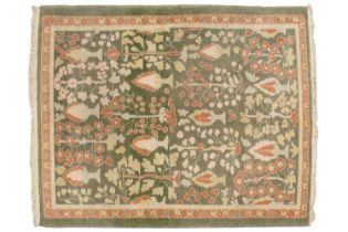 A Ziegler-style Lovett green ground rug with ivory and brick red Cypress tree motif within a