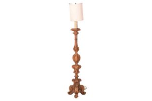 An Italian-carved walnut altar candlestand now with electric fittings, probably 18th century. 124 cm