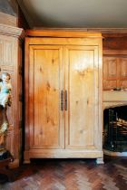 A 19th century Continental maple armoire, the moulded cornice over a pair of panelled doors, on