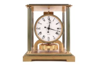 A Jaeger LeCoultre Atmos clock, the glass and brass case with green enamel highlights and corner