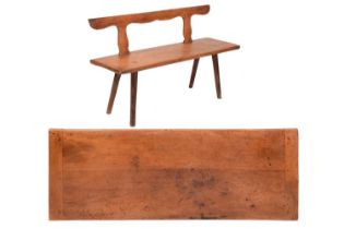 A 19th-century fruitwood Tyrolean primitive bench with a simple upstand rail back with four hewn