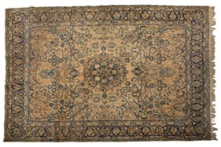 A large antique "Country House" Mahal carpet with a faded ivory ground with a central boss and